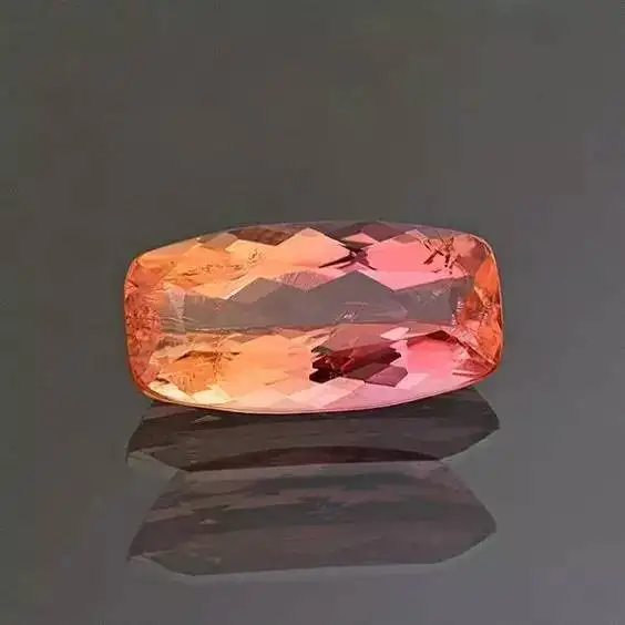 A bi-color Brazilian topaz, showcasing a stunning transition from pink to yellow, a beautiful and rare example of natural multi-colored topaz.