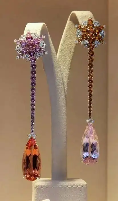 A jewelry set of earrings and a pendant featuring yellow topaz stones in rich brown and tan hues.