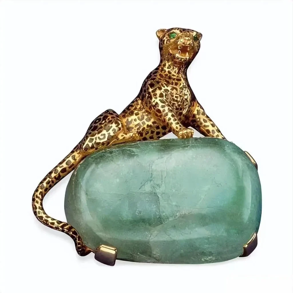 A vintage handmade brooch inspired by Cartier's Flamingo design for the Duchess of Windsor, crafted in platinum and set with rubies, sapphires, and emeralds, depicting a proud standing flamingo.