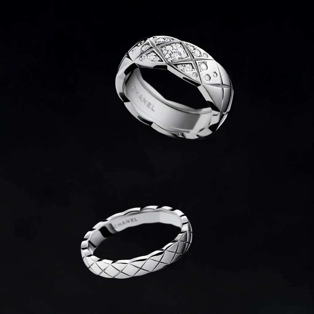 An illustration of pieces from the CHANEL COCO CRUSH Fine Jewelry collection. The design showcases the brand's iconic quilted matelassé pattern, with bold, graphic lines on a variety of gold rings, bracelets, and earrings.