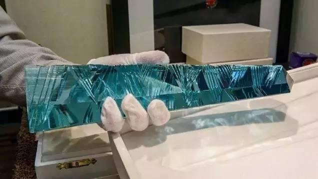 Cut aquamarine gemstone displaying polished facets and vivid blue-green color