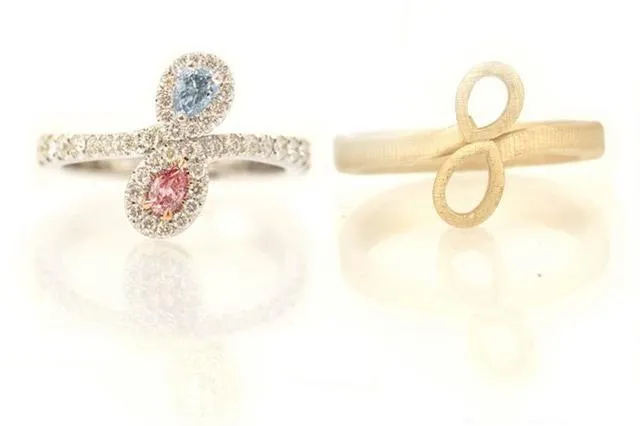 Individual gold jewelry pieces, freshly cut from the casting tree, ready for the next finishing stages.