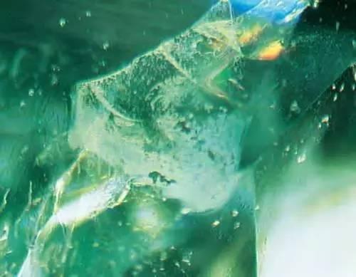 Filling material in an emerald turning cloudy over time, illustrating the clarity enhancement process in this Emerald Buying Guide