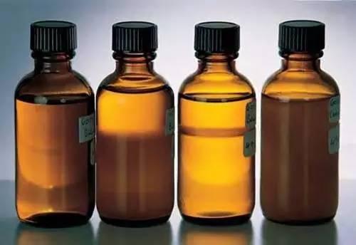 Bottles containing materials used for emerald clarity enhancement, including colorless oils, colored oils, and resins