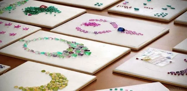 Illustration of various colored gemstones arranged for inlay on jewelry.