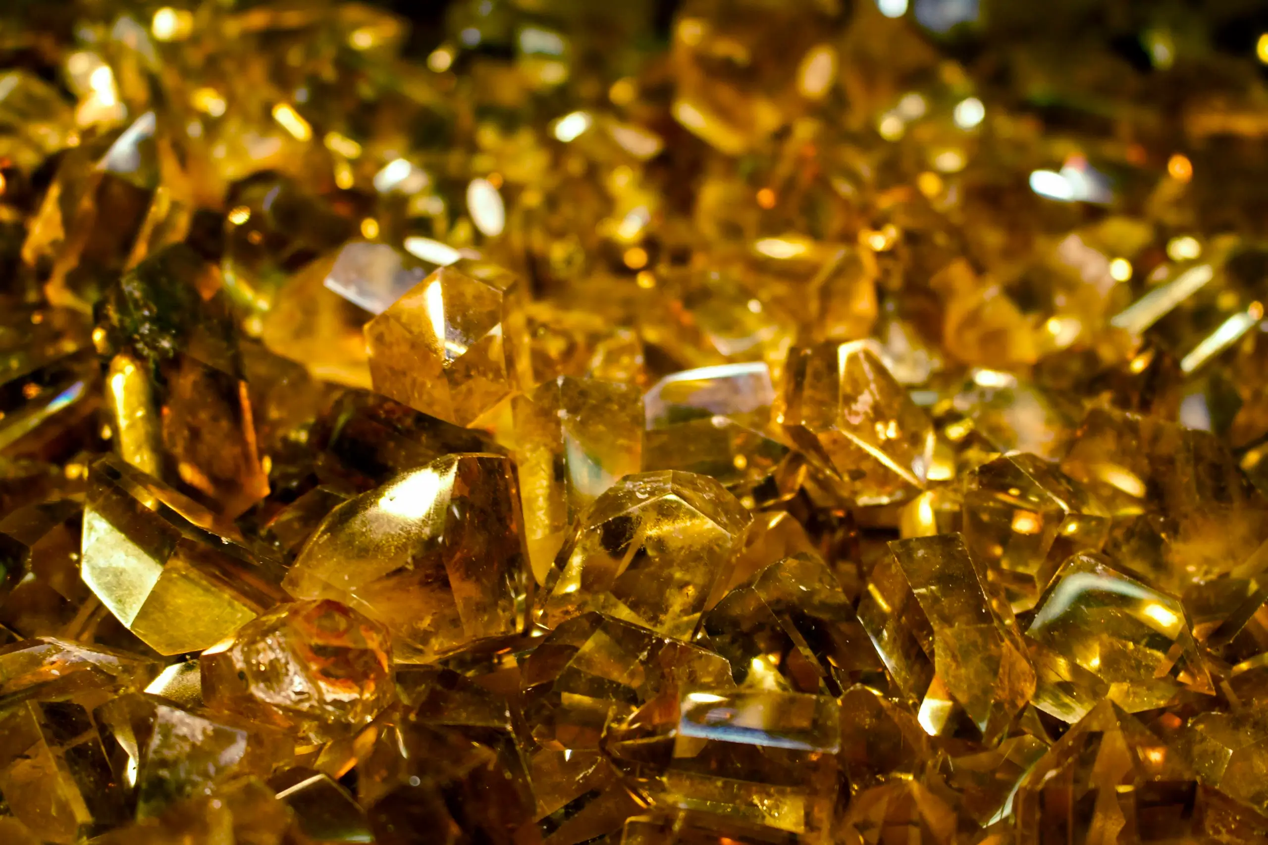 Close-up of golden beryl crystals showing intricate facets, highlighting its rare beauty and cat's eye effect.