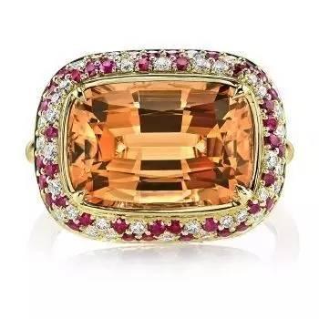 An elegant ring with a central golden yellow topaz stone surrounded by sparkling diamonds.