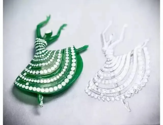 A detailed, hand-carved wax model of a dancing figure for a custom jewelry piece.