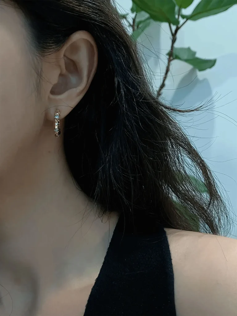 Handmade earrings are showcased on a model to highlight everyday wear style.