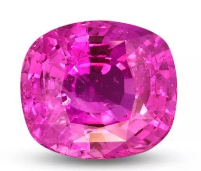 A gemstone graded as Hot Pink, which can be classified as either a ruby or a pink sapphire.