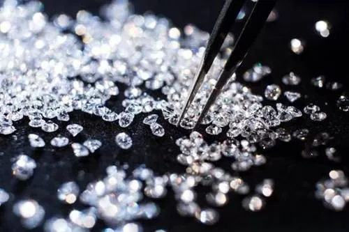 An illustration of hundreds of sparkling diamonds scattered on a piece of luxurious black velvet.