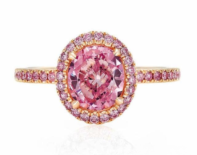 Intense pink diamond set in rose gold with matching pink accent diamonds, showing how warm-toned metal enhances the richness of the pink hue and makes the main stone appear larger.