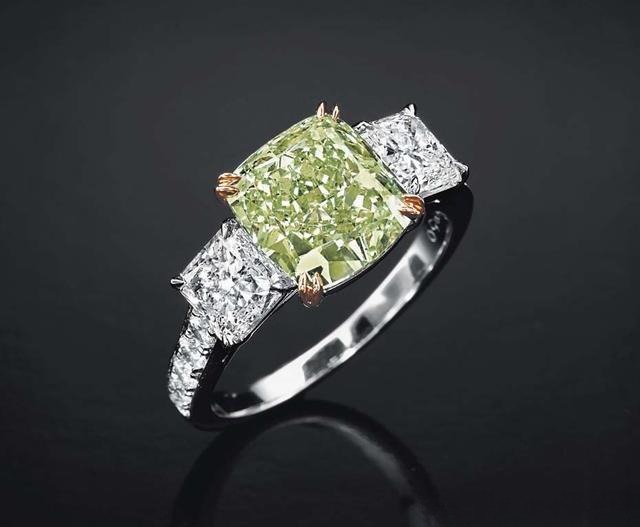 Light green diamond ring set in a platinum band, showing how pale-colored diamonds are mounted in platinum or white gold to avoid color interference.
