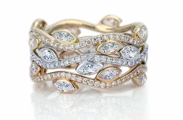 An illustration of a gold triple-band ring with a central diamond and smaller accent stones, creating a layered and luxurious look.