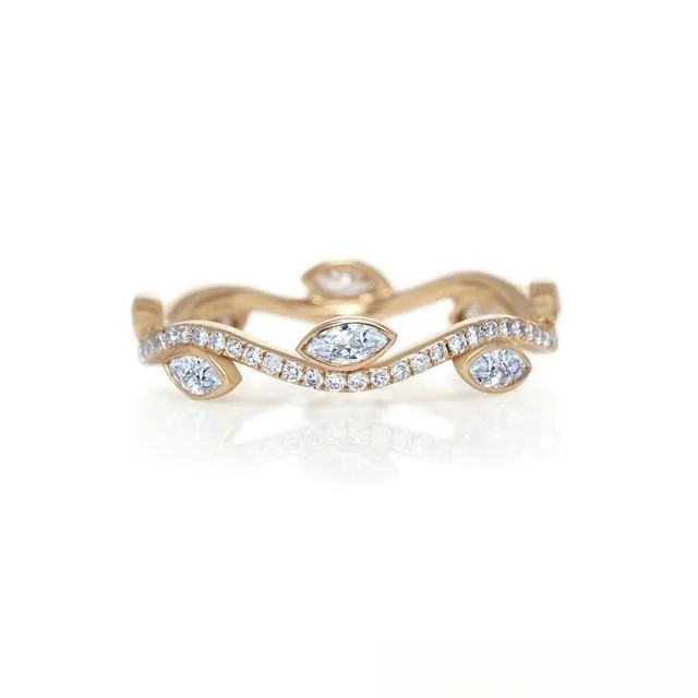 Minimalist gold ring with a slender band and a delicate marquise diamond, showcasing an elegant and streamlined design.