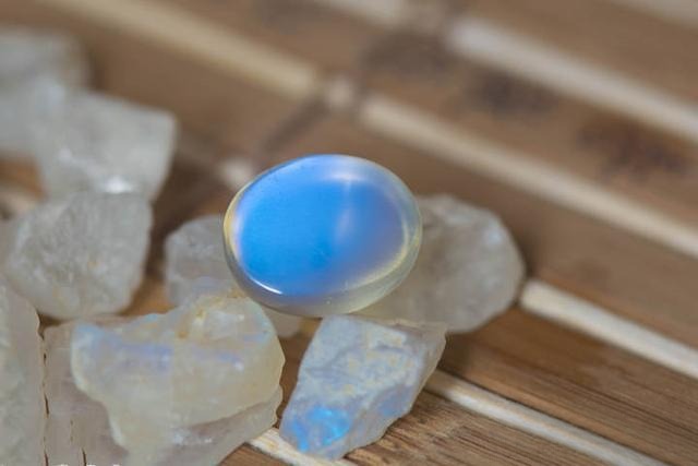 Bottom view of a moonstone showing stronger and more extensive blue adularescence compared to the top surface.