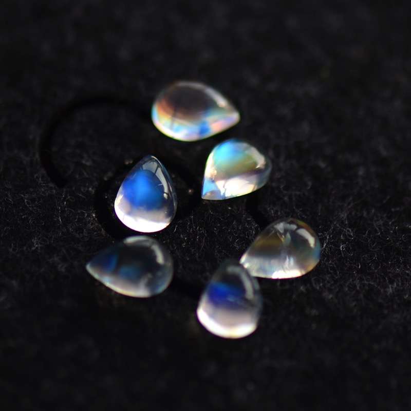Close-up of a mesmerizing moonstone, the June birthstone, showing its mystical blue adularescence.