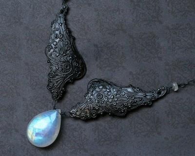 Moonstone jewelry June birthstone pendant necklace symbolizing wealth, health, and longevity with its gentle blue adularescence.