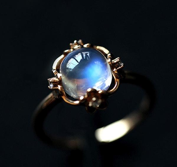 Close-up of a June birthstone moonstone ring displaying a mesmerizing blue adularescence.