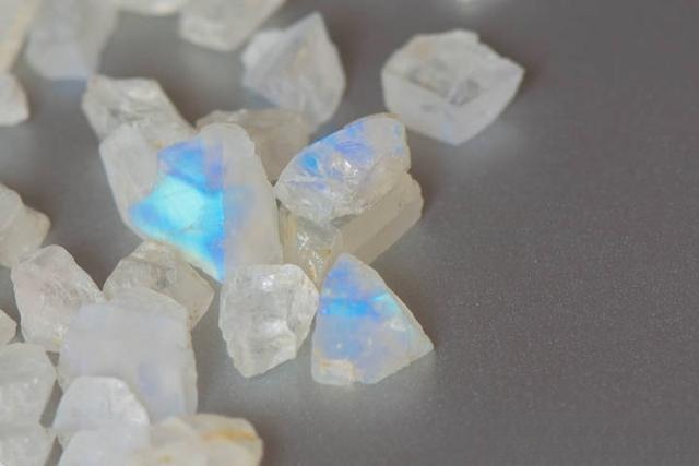 Detailed view of a moonstone rough highlighting subtle inclusions and yellowish adularescence, adding unique character.