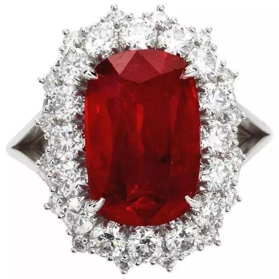 Pigeon’s blood ruby ring with vivid red center stone and diamond accents