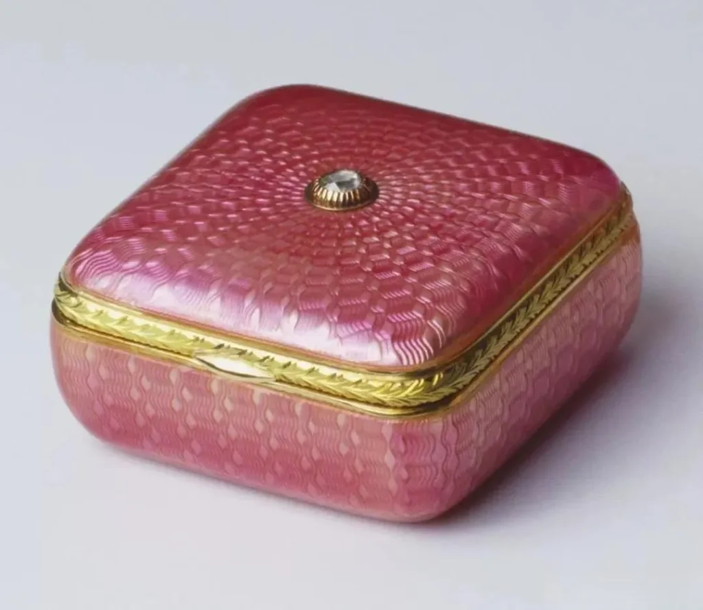  An illustration of an exquisite pink Fabergé jewelry box. The box's surface is decorated with intricate enamel and metalwork, possibly also set with gemstones. Its design is luxurious and elegant, filled with the opulent flair of royal artistry.