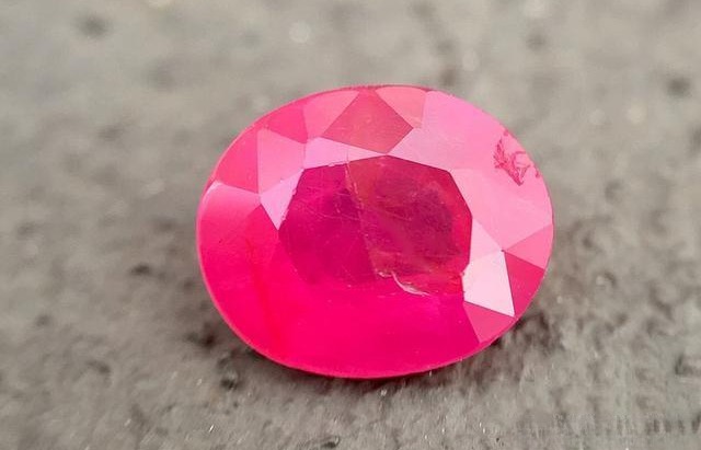 Pink gemstone crystal rough with natural inclusions and vivid color.