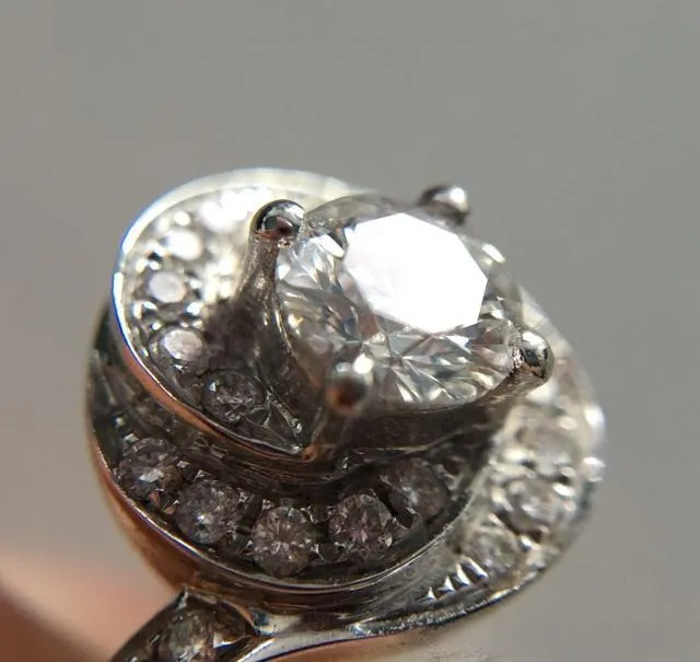 A detailed diagram illustrating the prong setting technique, a fundamental jewelry craftsmanship method showing how the metal claws securely hold a gemstone.