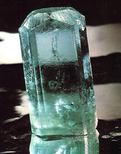 Raw aquamarine gemstone crystal showcasing natural blue-green color and texture