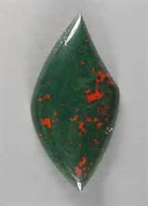 Red Jasper with hematite blood-red and reddish-brown spots on dark to green background, resembling drops of blood