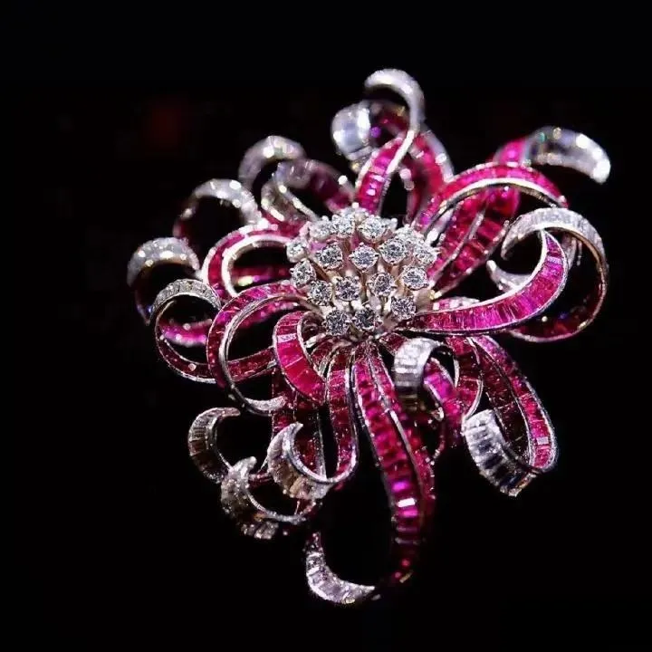 An illustration of a ruby rose brooch. The brooch is shaped like a blooming rose, with petals composed of meticulously carved rubies, possibly accented with diamonds or other gemstones. The design is opulent and passionate, beautifully combining the timeless elegance of a flower with the brilliant luster of gemstones.