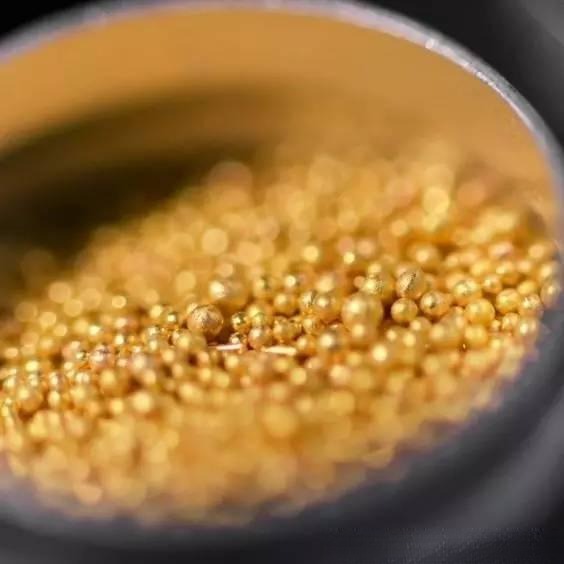 Tiny gold beads fused on a surface showing Jewelry Metal Texturing Techniques granulation detail