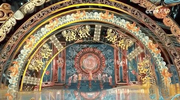 An intricate illustration of a traditional pattern, featuring swirling lines, geometric shapes, and floral motifs in rich, earthy colors.