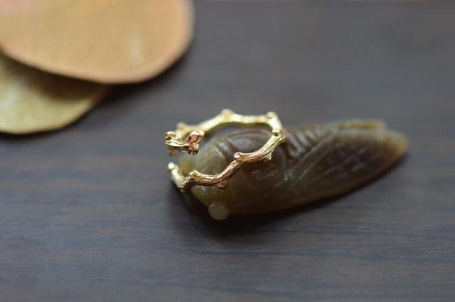 Decorative metal piece featuring intricate tree-grain texture and organic patterns