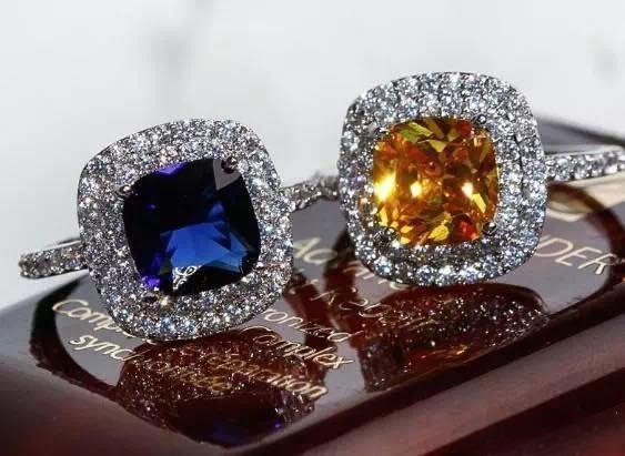 Two gemstone rings surrounded by sparkling zircon accents, shining brightly