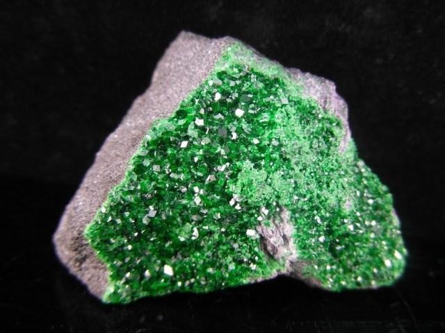 Rough uvarovite garnet crystal showing vivid green color and natural crystal structure