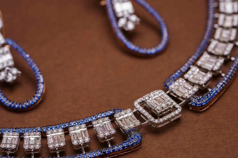 Close-up of a sapphire and diamond jewelry set, representing the beauty and elegance of Vietnam pink sapphires, on a brown background.