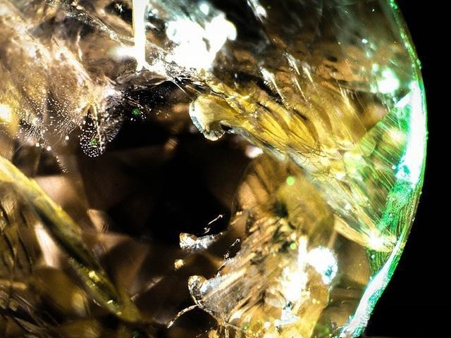 Microscopic view of Vietnam pink sapphires showing visible internal fractures; many rough stones are cut as cabochons due to numerous cracks