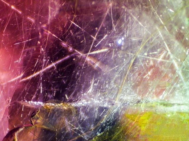 Microscopic view of Vietnam pink sapphires showing numerous random needle-like inclusions, some fine, some coarse, appearing fuzzy and dull