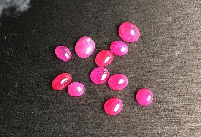 Vietnamese red sapphires cut as cabochons, resembling candy-like gems that shine with irresistible charm despite their imperfections.