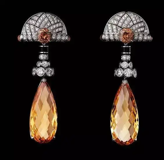 A set of yellow topaz and diamond jewelry, including pendant and earrings, showcasing Topaz colors and value with bright yellow stones and sparkling diamonds.