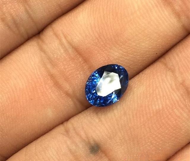 3.02-carat unheated blue sapphire with poor cut and irregular shape — illustrating that carat weight alone has little meaning without quality gemstone cut.