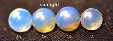 Blue amber on a black background under sunlight, with most visible light absorbed to reveal its blue fluorescence.