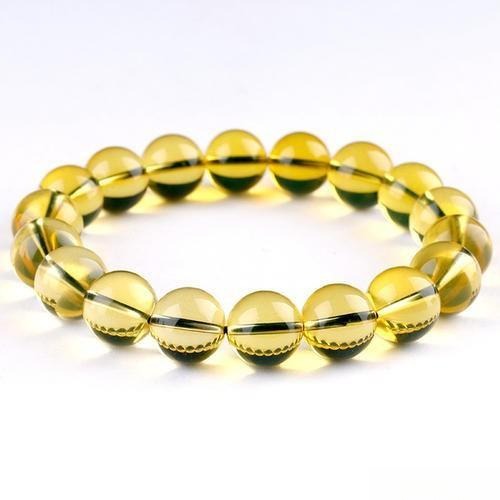 Blue amber bracelet appearing yellow in natural daylight, illustrating how buyers can be misled by advertised "blue" color – Gemstone Jewelry Buying Tips.