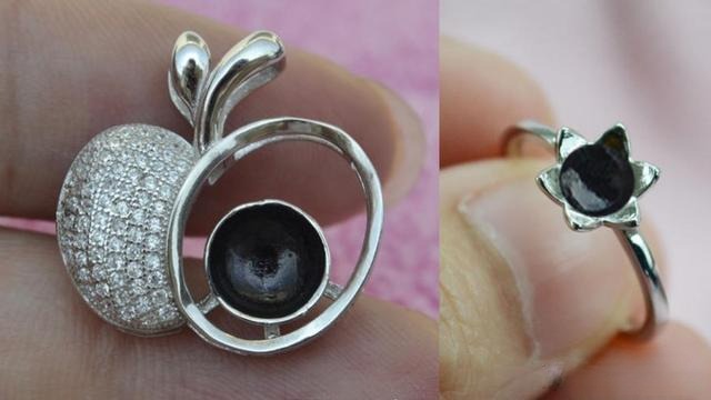 Blue amber ring displayed on a black background to enhance its blue color in photos and presentations.