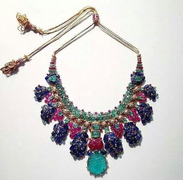 Cartier Tutti Frutti emerald necklace featuring carved gemstones in vivid colors, showcasing harmonious design through varied cuts and balanced arrangement.