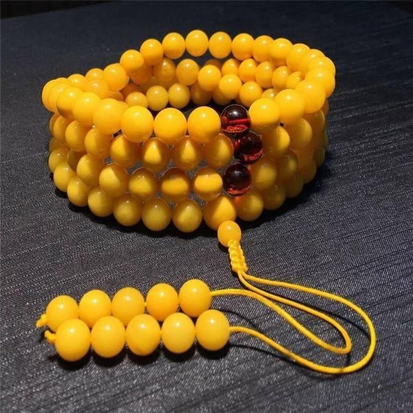 Chicken-oil yellow beewax bracelet, showing warm golden yellow beads from lightly heat-treated amber.