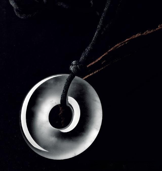Handcrafted circular jade pendant highlighting natural A-jade quality, translucency, and artisan design.
