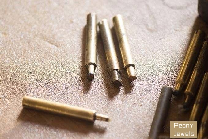 Copper dop stick securely holding the stone in place during preparation