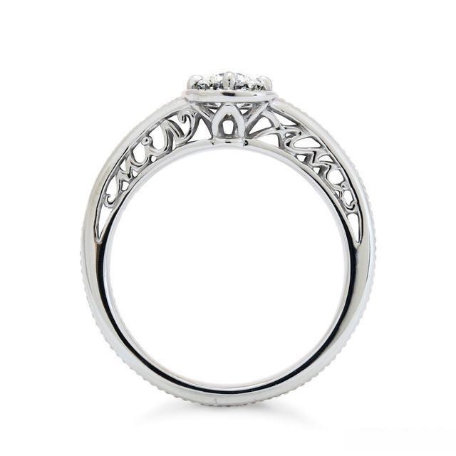 A custom-designed ring with an engraved band, featuring a detailed and personalized pattern that enhances the overall elegance and individuality of the ring.